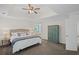 Spacious main bedroom features a tray ceiling, fan, neutral colors, and private ensuite bath at 640 Windwalk Dr, Roswell, GA 30076