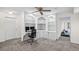 Home office with custom built-in shelving, cabinets, and plush carpet at 640 Windwalk Dr, Roswell, GA 30076