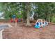 Community playground with train-themed climber, slide, and climbing structure amidst mature trees at 640 Windwalk Dr, Roswell, GA 30076