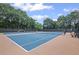 Well-maintained community tennis courts surrounded by mature trees and lighting for evening play at 640 Windwalk Dr, Roswell, GA 30076