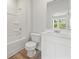 All-white bathroom features a tub/shower combo and modern vanity at 2645 Mourning Dove Drive (Lot 49), Grayson, GA 30017