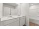 Bright bathroom features a double vanity, mirror, white cabinets, and a shower and tub combination at 2645 Mourning Dove Drive (Lot 49), Grayson, GA 30017