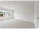 Light-filled bedroom with soft carpeting and view of the neighborhood through the windows at 2645 Mourning Dove Drive (Lot 49), Grayson, GA 30017