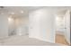 Bright hallway features plush carpet and a door leading to a bathroom with a shower and tub at 2645 Mourning Dove Drive (Lot 49), Grayson, GA 30017