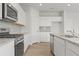 Modern kitchen featuring stainless steel appliances, granite countertops, and sleek design at 2645 Mourning Dove Drive (Lot 49), Grayson, GA 30017