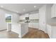 Well-lit kitchen with white cabinets, granite countertops, stainless appliances and wood-look flooring at 2645 Mourning Dove Drive (Lot 49), Grayson, GA 30017