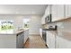 Contemporary kitchen boasts granite counters, stainless appliances, and an open layout at 2645 Mourning Dove Drive (Lot 49), Grayson, GA 30017