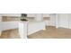 Bright kitchen features white cabinets, stainless steel appliances, and a center island at 2645 Mourning Dove Drive (Lot 49), Grayson, GA 30017