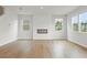 Bright living room features hardwood floors, a modern fireplace, and natural lighting at 2645 Mourning Dove Drive (Lot 49), Grayson, GA 30017