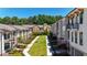 Aerial view of townhome community featuring central green space and manicured landscaping at 348 Olmstead Way # 30, Alpharetta, GA 30022