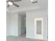 Spacious bedroom with neutral carpet, tray ceiling, and access to walk-in closets at 348 Olmstead Way # 30, Alpharetta, GA 30022
