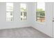 This bedroom offers neutral carpet, white walls, and natural light from the windows at 348 Olmstead Way # 30, Alpharetta, GA 30022