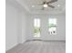 Bright bedroom with a ceiling fan, neutral carpet, and a door leading to a balcony at 348 Olmstead Way # 30, Alpharetta, GA 30022