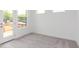 Bedroom with neutral carpet, bright white walls, and door leading to outdoor space at 348 Olmstead Way # 30, Alpharetta, GA 30022