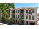 Exterior view of modern townhome community with brick accents and lush landscaping at 348 Olmstead Way # 30, Alpharetta, GA 30022