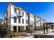 Beautiful townhouse exterior with brick accents, balconies, and manicured landscaping on a sunny day at 348 Olmstead Way # 30, Alpharetta, GA 30022