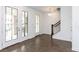 Bright foyer showcasing hardwood floors, staircase, and front entry with glass-paneled sidelights and doors at 348 Olmstead Way # 30, Alpharetta, GA 30022