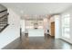 Open-concept space with kitchen featuring island, stainless appliances, and hardwood floors, adjacent to living area at 348 Olmstead Way # 30, Alpharetta, GA 30022