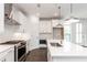 Modern kitchen features white cabinets, stainless steel appliances, and a large island with quartz countertop at 348 Olmstead Way # 30, Alpharetta, GA 30022