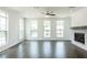 Bright living room featuring hardwood floors, large windows, and a stone fireplace at 348 Olmstead Way # 30, Alpharetta, GA 30022
