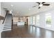 Spacious living area featuring hardwood floors, a stone fireplace, and a kitchen at 348 Olmstead Way # 30, Alpharetta, GA 30022