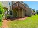 A lush lawn, mulch, and covered deck create an inviting backyard at 442 Colonial Walk, Woodstock, GA 30189