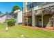 Green lawn, multiple decks, and tidy landscaping enhance this cozy backyard at 442 Colonial Walk, Woodstock, GA 30189