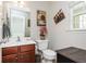 A convenient half-bathroom is adjacent to the main floor entrance with a sink and toilet at 442 Colonial Walk, Woodstock, GA 30189