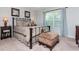 Comfortable bedroom features neutral walls, carpet, upholstered bench, with traditional furniture and decor at 442 Colonial Walk, Woodstock, GA 30189
