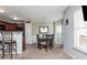 The dining room features a chandelier over a dark wood table, with large windows bringing in lots of light at 442 Colonial Walk, Woodstock, GA 30189