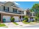 Charming townhome featuring brick accents, individual garages and verdant landscaping at 442 Colonial Walk, Woodstock, GA 30189