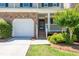 Lovely townhome with an attached garage and pleasant curb appeal at 442 Colonial Walk, Woodstock, GA 30189