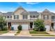 Inviting townhomes with garages and covered entries, showcasing a blend of brick and siding at 442 Colonial Walk, Woodstock, GA 30189