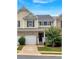 Charming townhome featuring a one-car garage and inviting entryway with classic architectural details at 442 Colonial Walk, Woodstock, GA 30189