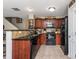 A well-equipped kitchen boasts dark granite counters, wood cabinets, and stainless steel appliances at 442 Colonial Walk, Woodstock, GA 30189