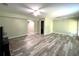 Open living area features hard surface floors, neutral walls, and two ceiling fans at 442 Colonial Walk, Woodstock, GA 30189