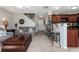 A cozy living room features a comfortable gray sofa and a dark wood coffee table with seating at the kitchen bar at 442 Colonial Walk, Woodstock, GA 30189
