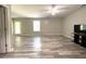 Open living area features hard surface floors, neutral walls, a TV, and exterior view at 442 Colonial Walk, Woodstock, GA 30189