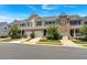 Charming street view showcasing attractive townhomes with attached garages and well-maintained lawns and landscaping at 442 Colonial Walk, Woodstock, GA 30189