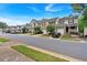 Street showcasing townhomes with well-kept lawns and tree-lined streets, creating a welcoming community at 442 Colonial Walk, Woodstock, GA 30189