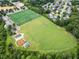 Aerial view of fields, playgrounds, and neighborhood in a lush, green setting at 6018 Oakdale Se Rd, Mableton, GA 30126