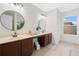 Bathroom showcasing dual sinks, a large mirror, custom vanity, and a window for natural light at 6018 Oakdale Se Rd, Mableton, GA 30126