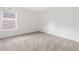 Bright bedroom featuring neutral carpeting, white walls, and a large window at 6018 Oakdale Se Rd, Mableton, GA 30126