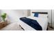 Neutral primary bedroom featuring a comfy bed, carpeted floors, and a navy throw blanket at 6018 Oakdale Se Rd, Mableton, GA 30126
