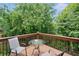 Inviting deck with table and chairs surrounded by lush greenery, perfect for relaxing outdoors at 6018 Oakdale Se Rd, Mableton, GA 30126