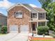 Charming two-story brick home with a two-car garage and a well-manicured front yard at 6018 Oakdale Se Rd, Mableton, GA 30126