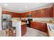 Open kitchen featuring stainless appliances, eat-in breakfast bar, and dark wood cabinets at 6018 Oakdale Se Rd, Mableton, GA 30126
