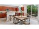 Bright kitchen with dark wood cabinets, breakfast bar, stainless appliances, and deck access at 6018 Oakdale Se Rd, Mableton, GA 30126