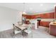 Eat-in kitchen boasts stainless steel appliances, wood cabinetry, and granite countertops at 6018 Oakdale Se Rd, Mableton, GA 30126