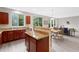 Open-concept kitchen with granite counters and island flows into a living area at 6018 Oakdale Se Rd, Mableton, GA 30126